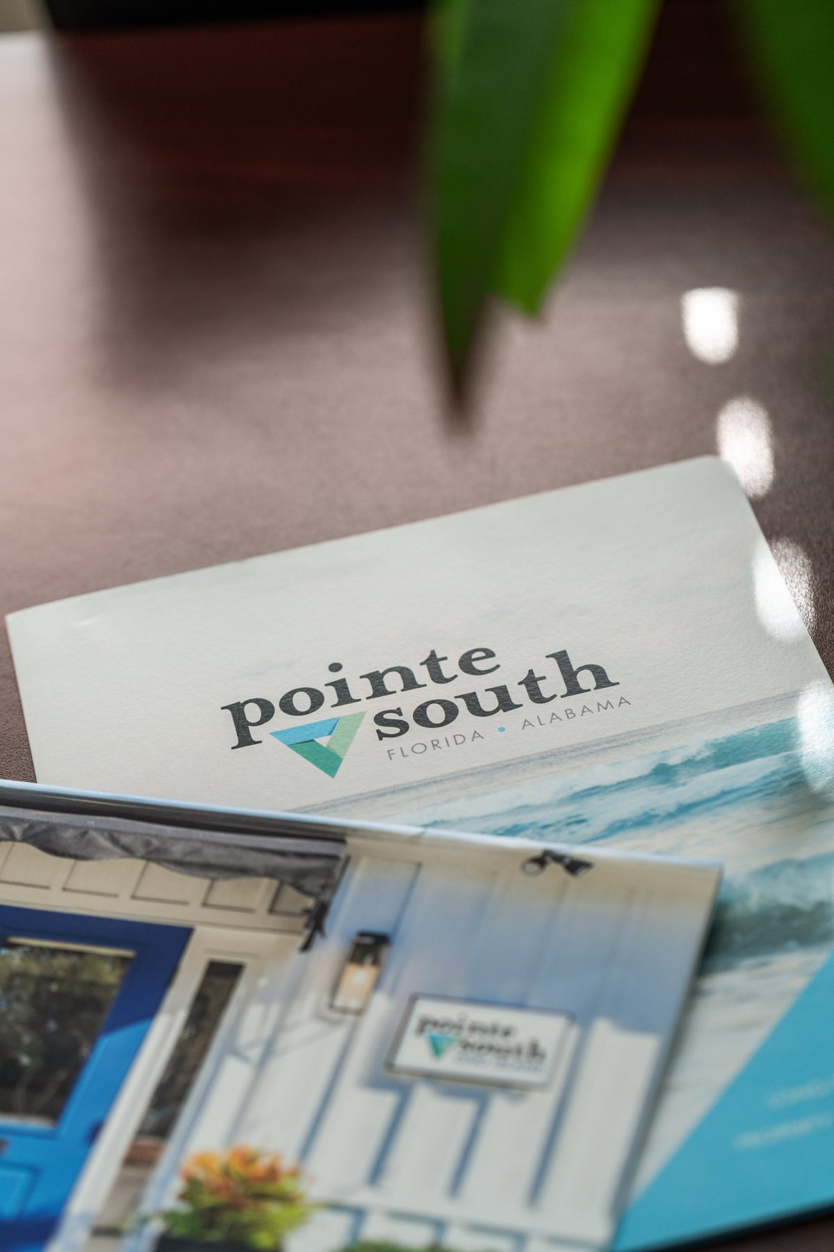 Pointe South brochures on the conference table, the office storefront printed on the cover — photo by Jimmy Warr