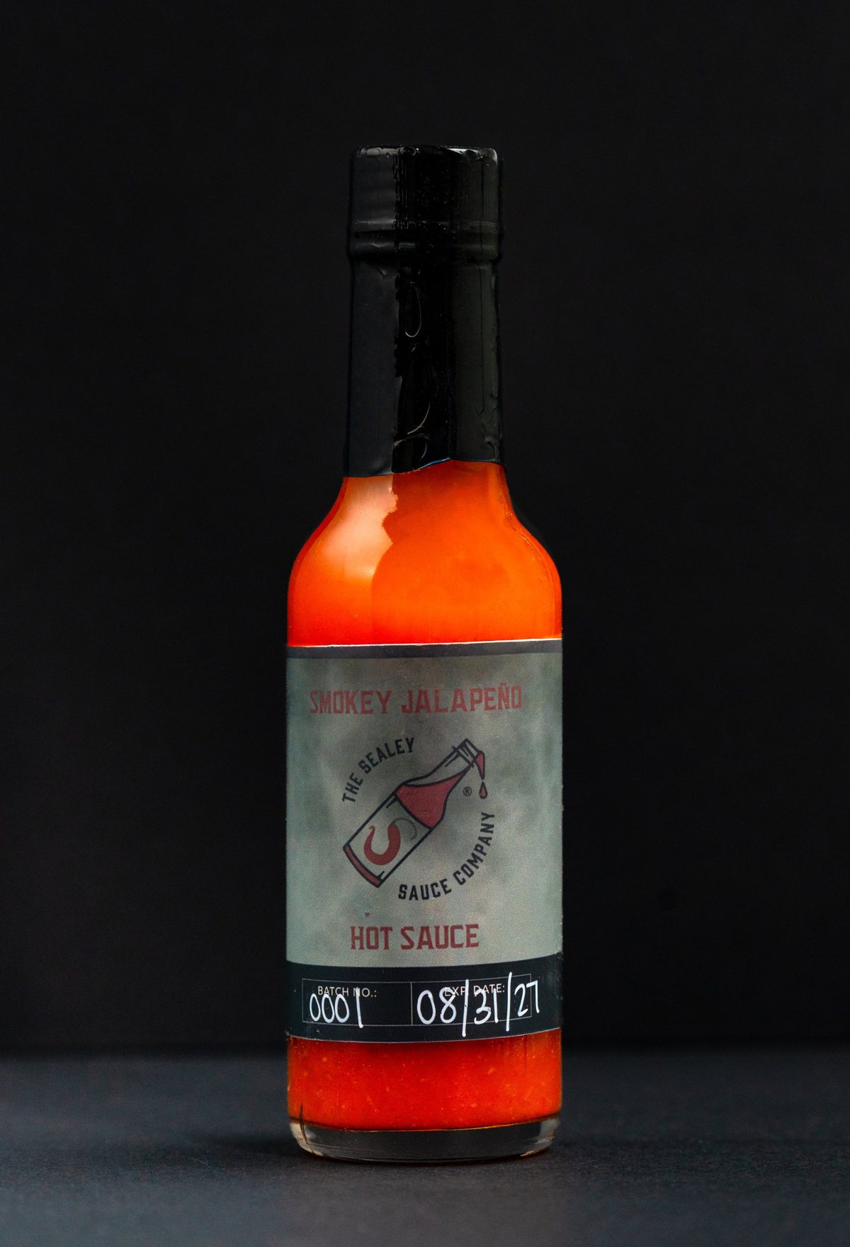 The Sealey Sauce Company Smokey Jalapeño hot sauce on black — photo by Jimmy Warr