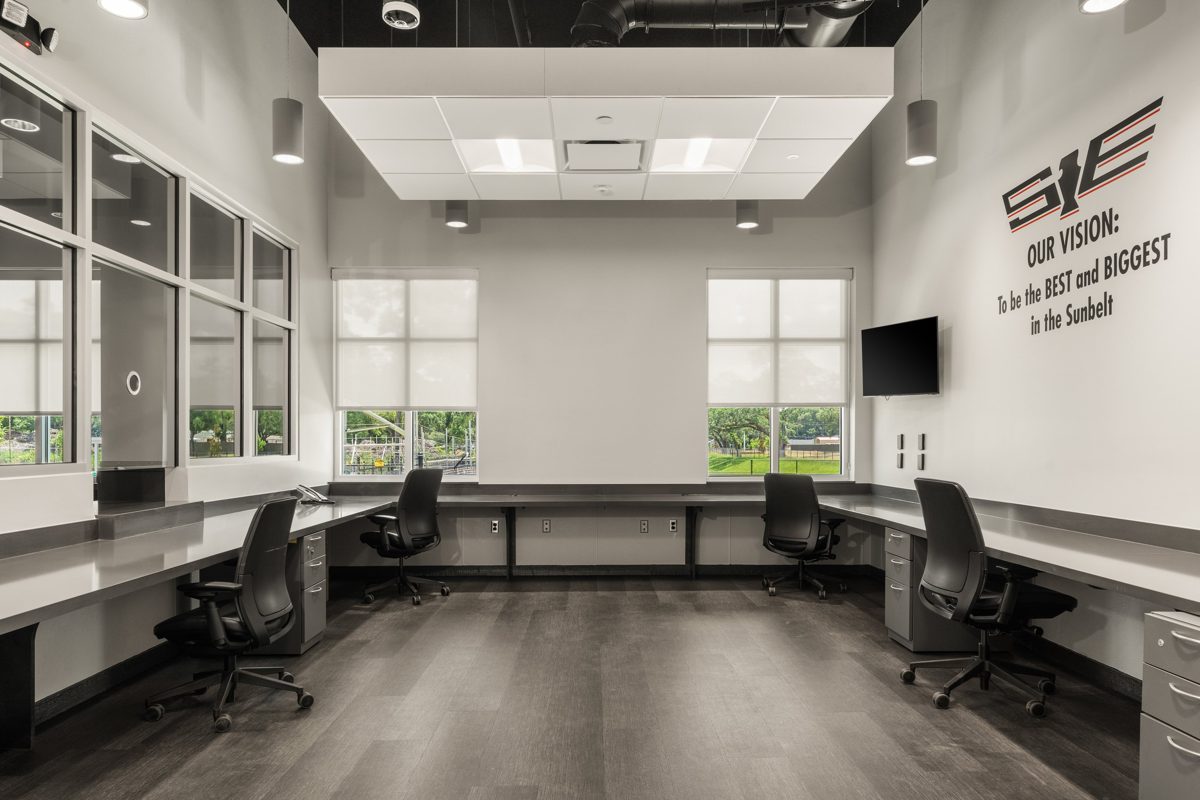 Dispatch room with long gray counters and the company vision lettered on the wall — photo by Jimmy Warr