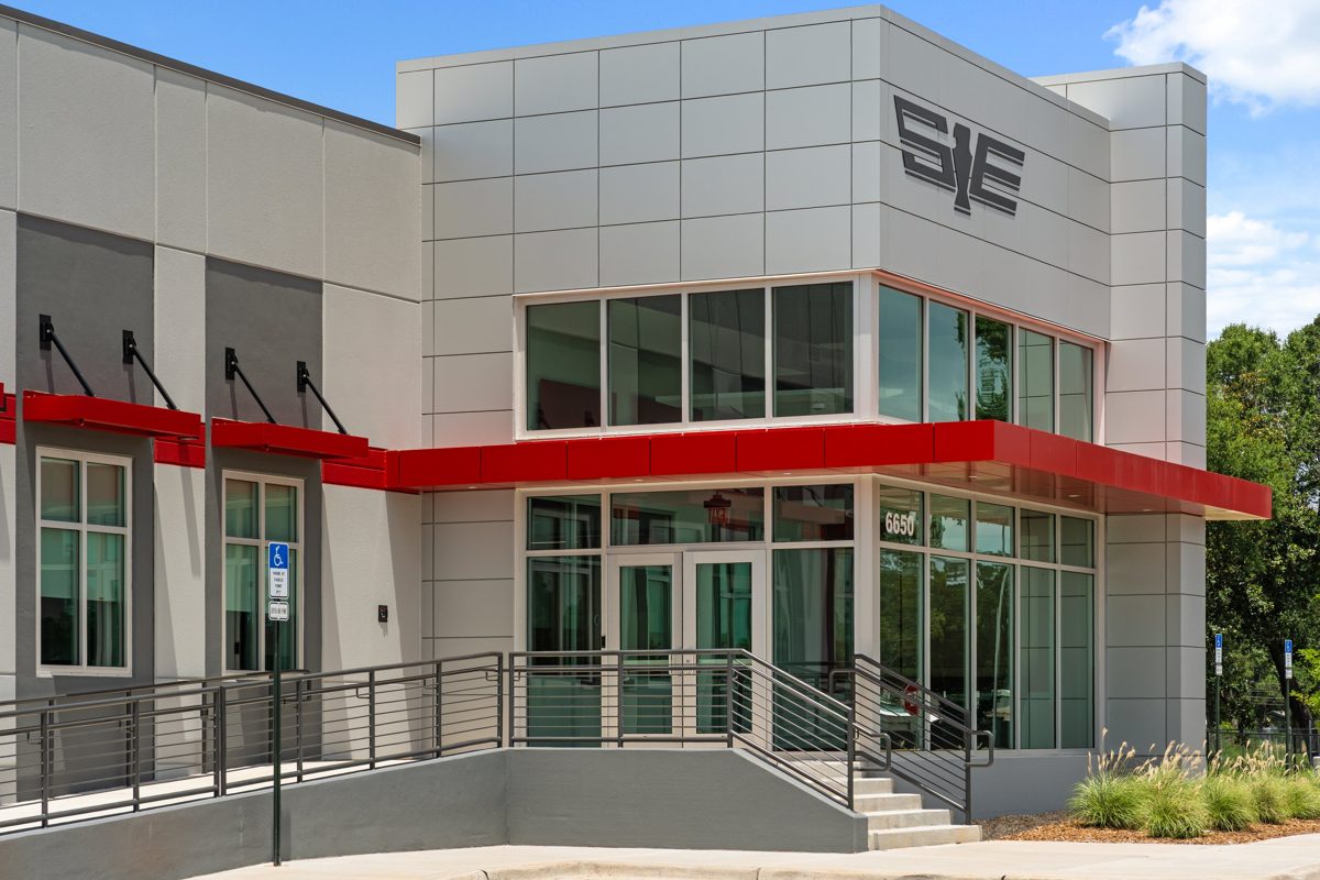 Entrance of the Southeastern Freight Lines building, with a red canopy wrapping a glass corner — photo by Jimmy Warr