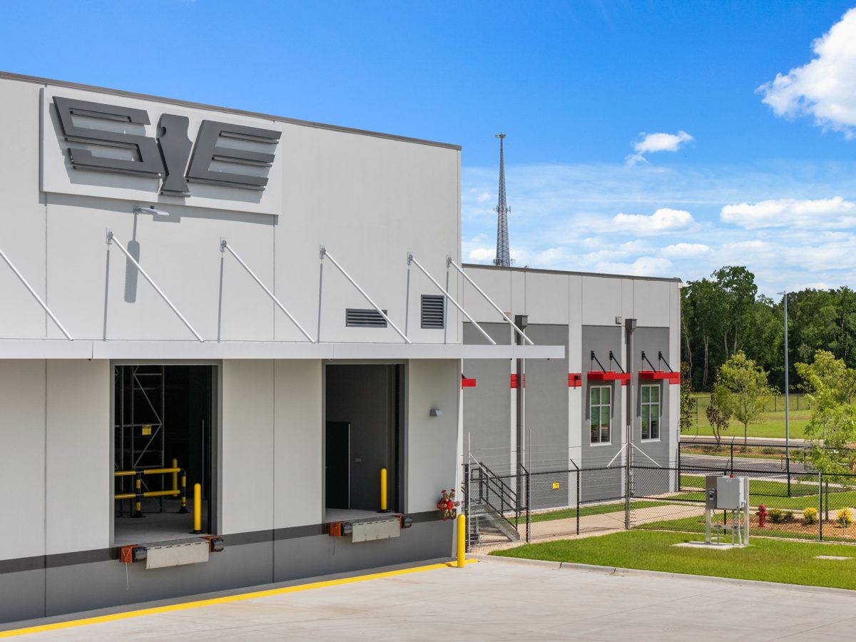 Loading docks with yellow bollards along the side of the facility — photo by Jimmy Warr