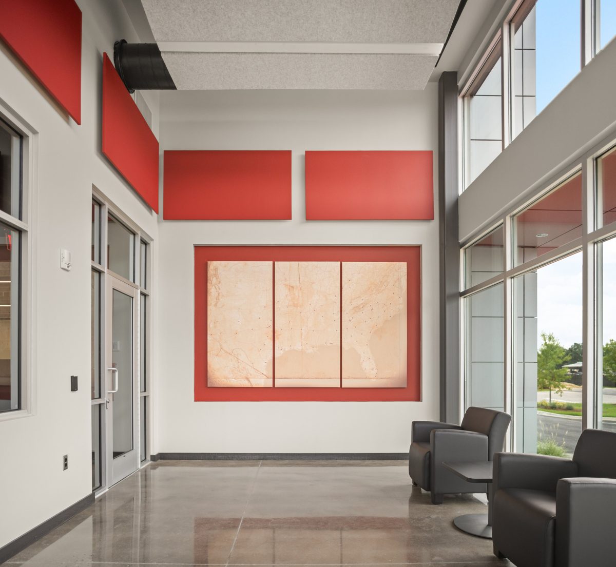 Lobby wall with a three-panel map of the Southeast set in a red frame — photo by Jimmy Warr
