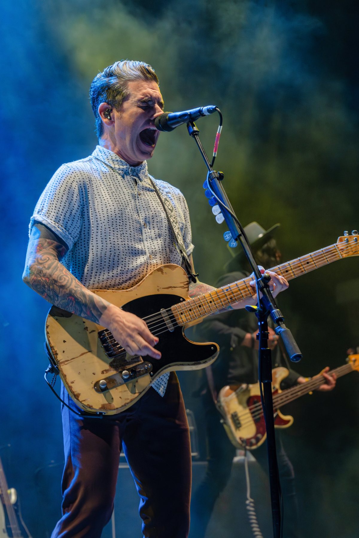 Dashboard Confessional frontman shouts into the mic through blue and green haze — photo by Jimmy Warr